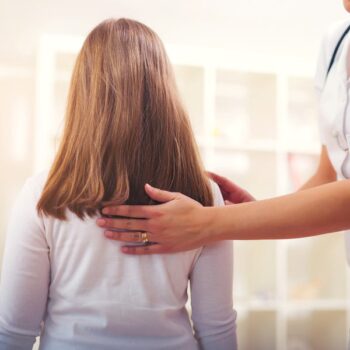 Chiropractor Doing Adjustment On Female Patient