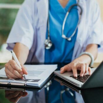 Medical Technology Concept. Doctor Working With Mobile Phone And Stethoscope